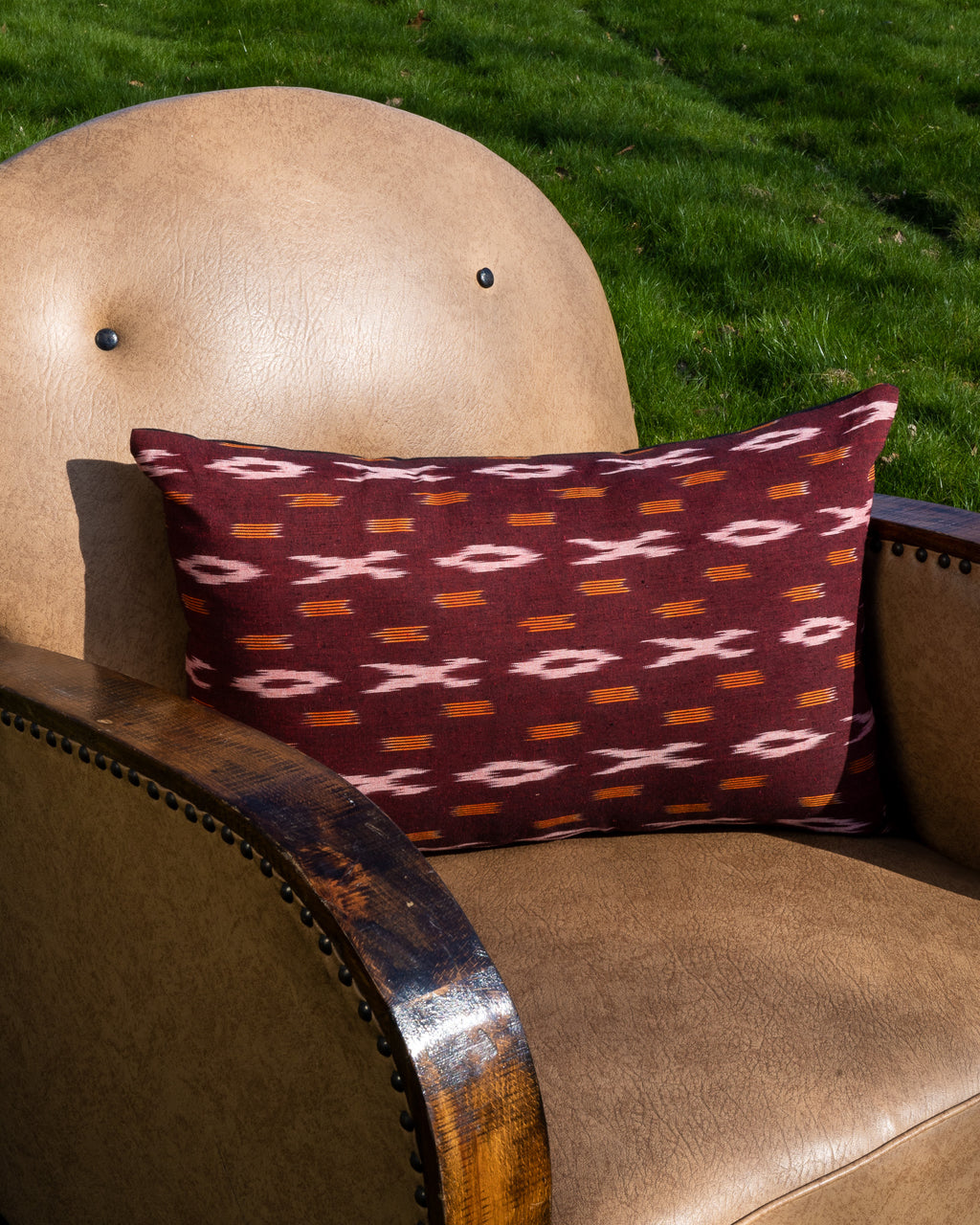 Pillow made from designer fabrics, deadstock fabrics, vintage fabrics, antique fabrics. A red patterned cotton ikat made in India.